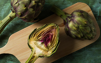 Artichokes sliced on a wooden board