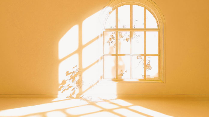 Young red-headed woman getting some sun from behind a window 